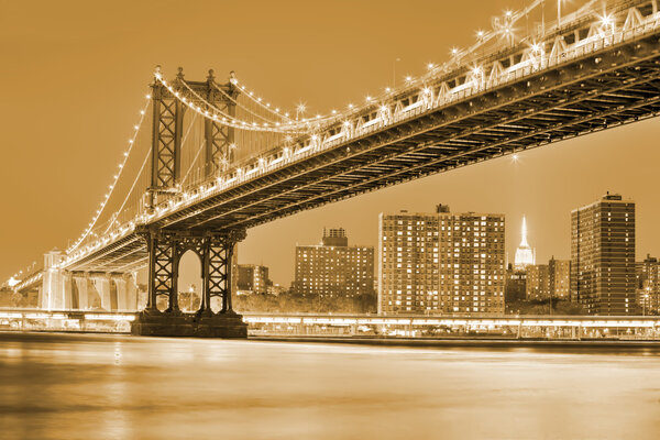 Night view of Manhattan bridgewith blured reflection in river