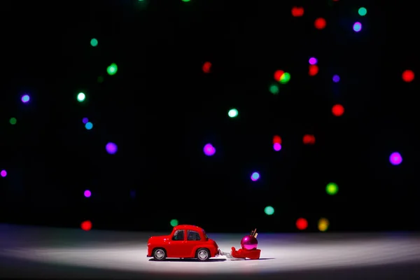 イルクーツク ロシア 2020年11月28日 クリスマスの前夜にクリスマスボールでそりを運ぶクリスマスの赤い車 ハッピーニューイヤーカードのコンセプト — ストック写真