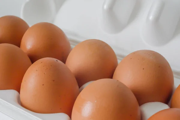 Brown chicken eggs in open package close-up. Healthy food concept