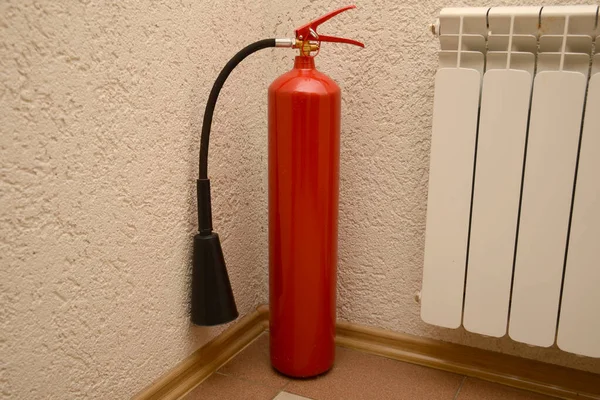 Red fire extinguisher in the office for safety during a fire. Safety concept