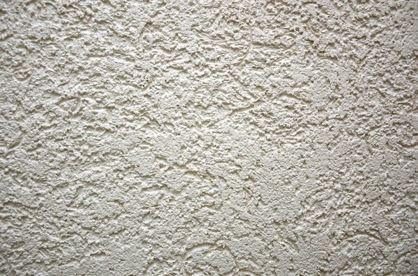 Evin engebeli beton duvarı. Kapalı alanda sıva, duvar dokusu beyaz