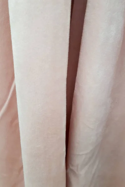 粉红天鹅绒窗帘的特写 在薄而厚的致密织物垂直褶皱中 纹理抽象的背景和壁纸 亚麻织物 纵向照片 — 图库照片