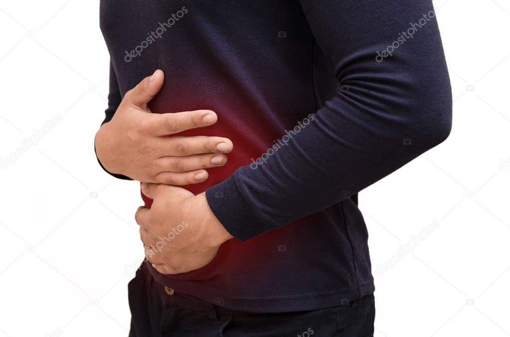 Young man suffers from stomach pain, red spot in the place of pain, isolated, horizontal color photo. Stomach disease concept