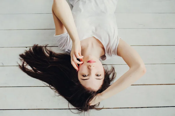 Beautiful girl lies on the floor Stock Photo