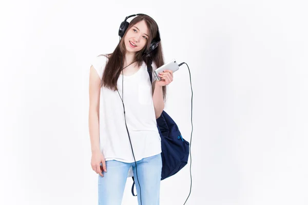 Young woman in headphones singing songs on a white background. — Stock Photo, Image