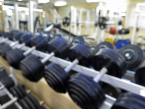 Imagen borrosa abstracta del gimnasio deportivo interior para fitness con fondo bokeh —  Fotos de Stock