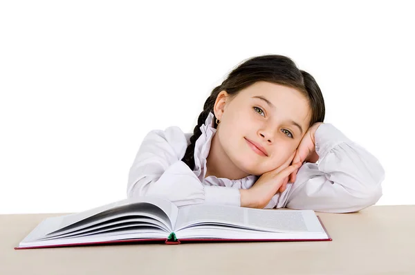 Bambina felice con un libro su sfondo bianco — Foto Stock