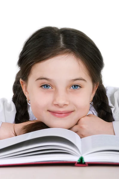 Close-up retrato criança menina feliz com um livro sobre um branco — Fotografia de Stock