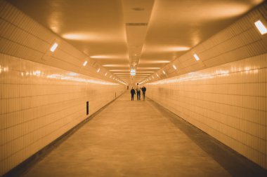 long empty white tunnel with lights