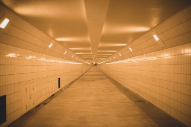 long empty white tunnel with lights