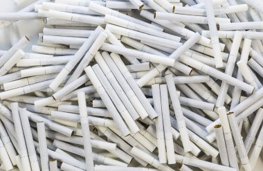 Yerdeki beyaz filtreli dağınık Sigara