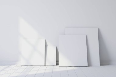 Blank canvases of paintings in an empty white room. 3d rendering