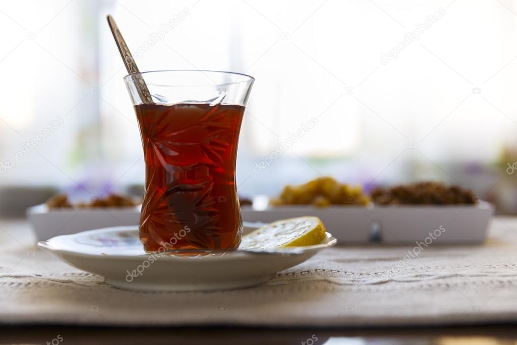 Azerbaijani tea with lemon and set nuts and sweets