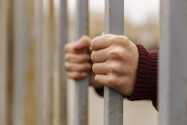 hands behind bars