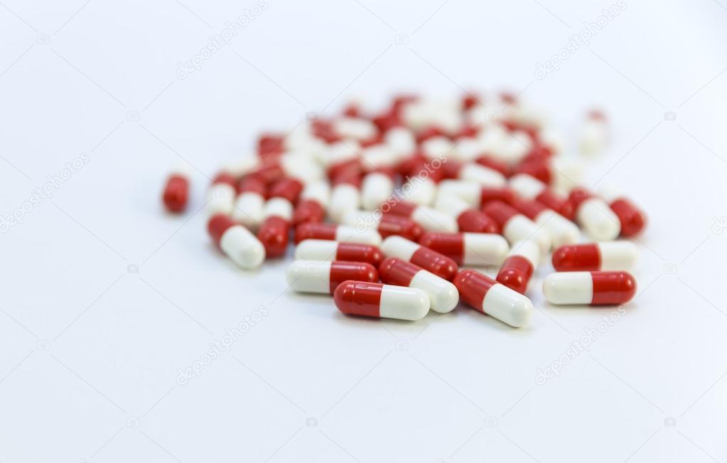 The drug in capsules of red and white on a white background