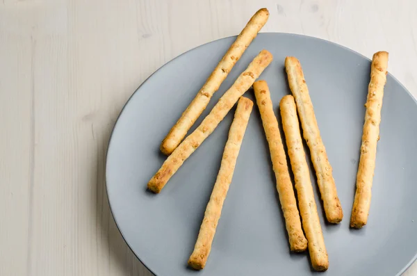 Rustik breadsticks bir tabak üzerinde ahşap masa, yakın çekim, arka plan