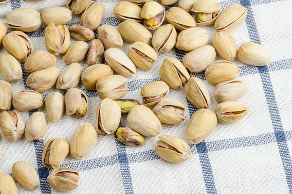 Roasted and salted pistachios on table cloth Stock Picture