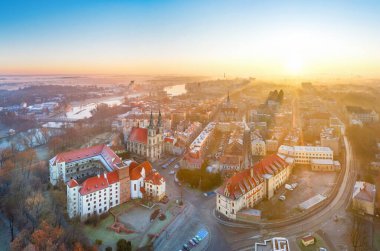 Brzeg, Poland. Aerial cityscape on sunrise with Piast castle and Church of the Holy Cross clipart