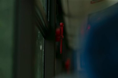 Otobüs acil durum aracı, güvenlik özelliklerine sahip kırmızı çekiç, yansıtıcı yüzeyi olan otobüs duvarına bağlı acil durum aracı, yansıtıcı güvenlik işaretli otobüse bağlı kırmızı acil durum çekici.