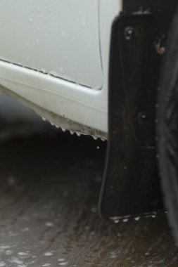 Sabunlu suya yakın çekim, lastik, su ve köpük damlacıklarına odaklan araç koruma özelliklerini vurgula, sabunlu suya ve tekerlek kemeri ve eteğin etrafındaki ıslak dokulara odaklan.