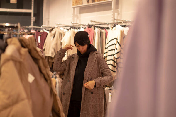 Winter wardrobe selections underway, Updating closet with seasonal stylish outerwear, Individual plans layered ensemble options for work commutes and leisure activities during winter