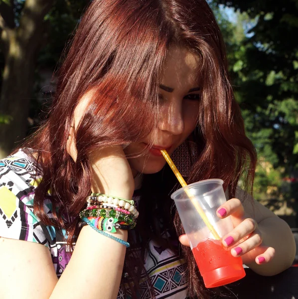 Young lady eating slush in the park — Stock Photo, Image