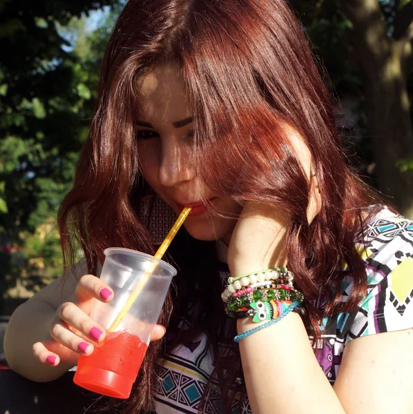 Young lady eating slush in the park — Stock Photo, Image