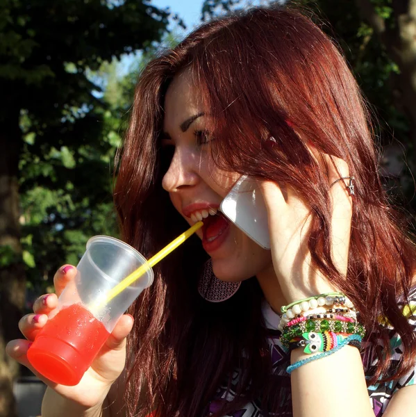 Young lady eating slush in the park — Stock Photo, Image