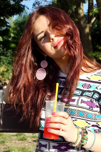 Young lady eating slush in the park — Stock Photo, Image