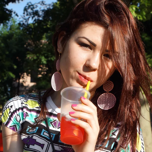 公園でスラッシュを食べる若い女性 — ストック写真