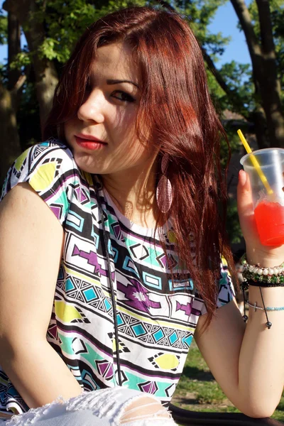 Young lady eating slush in the park — Stock Photo, Image