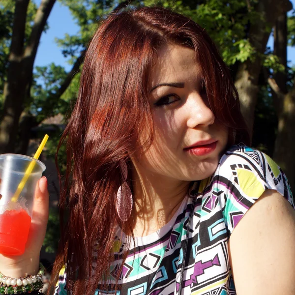 Young lady eating slush in the park — Stock Photo, Image