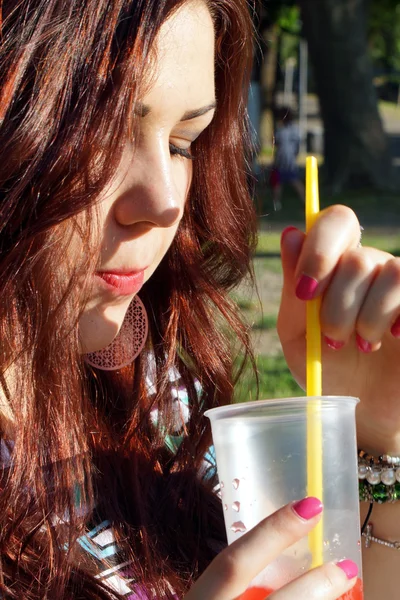 Young lady eating slush in the park — Stock Photo, Image