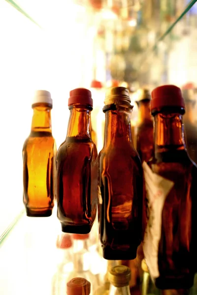 Collection of grappa bottles on shelf — Stock Photo, Image