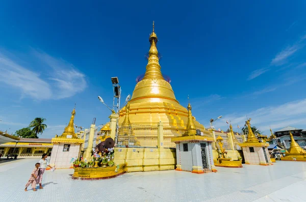 Sacred Bo Ta Tuang pagoda with blue sky background,  Yangon Stock Photo