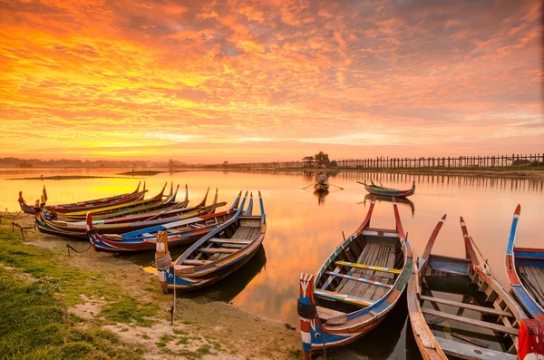 Wooden boat in Ubein Bridge at sunrise, Mandalay, Myanmar Stock Picture