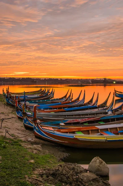 Wooden boat in Ubein Bridge at sunrise, Mandalay, Myanmar Stock Image