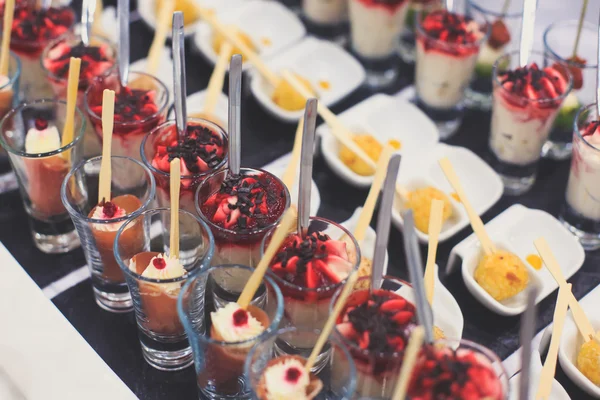 Beautifully decorated catering banquet table with different food snacks and appetizers with sandwich, caviar, fresh fruits on corporate christmas birthday party — Stock Photo, Image