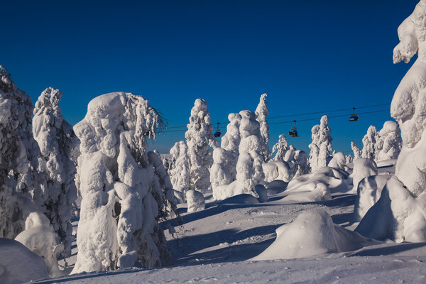 Beautiful cold mountain view of ski resort, sunny winter day with slope, piste and ski lift