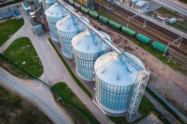 Aerial top view of Grain Elevator Silos, Granary of a feed mill built of modern metal structures, drone shot