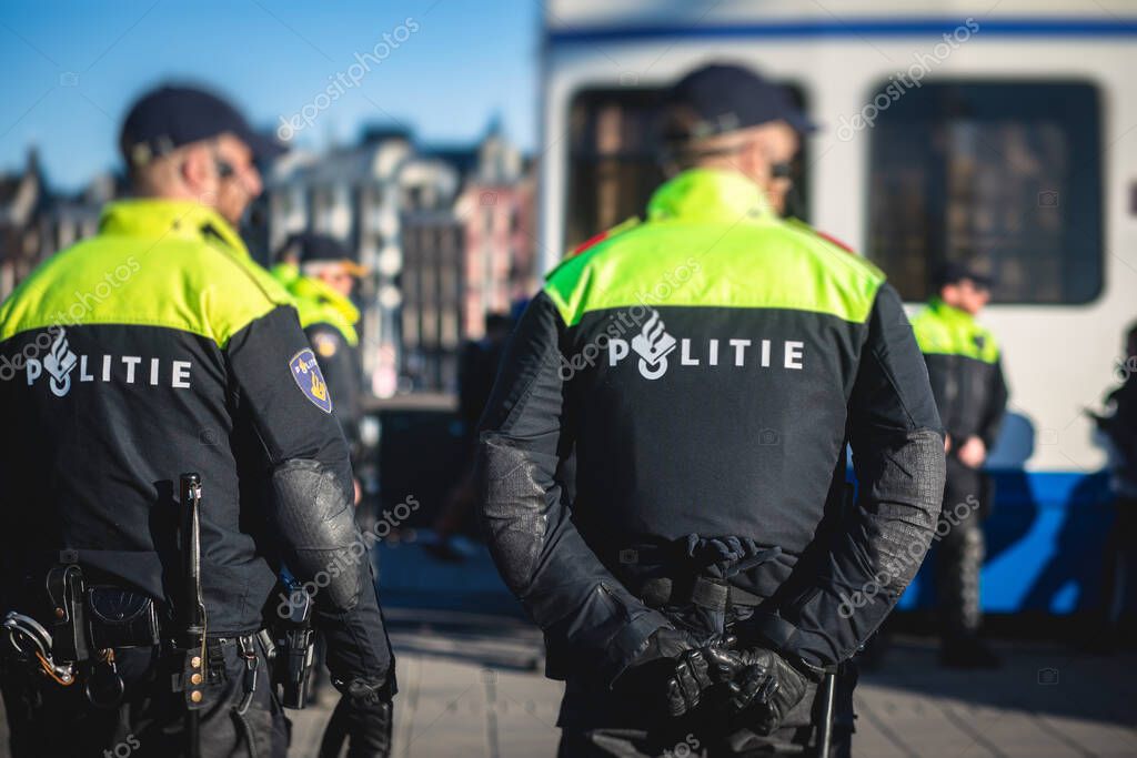 Dutch police squad formation and horseback riding mounted police back view with 
