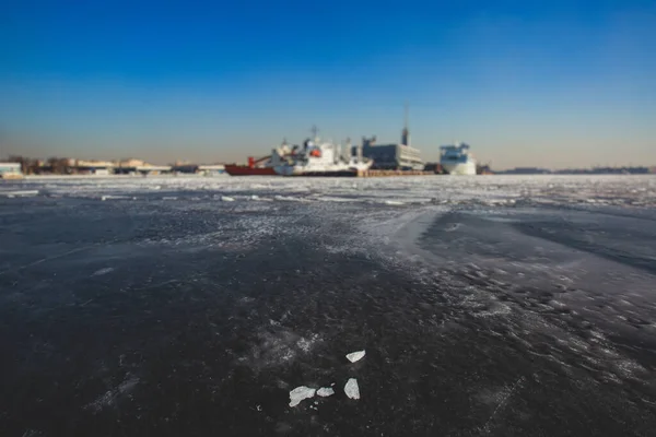 Massive different ship vessels trapped in ice tries to break and leave the bay between the glaciers, icebreaker and carrier vessel, winter blue sky