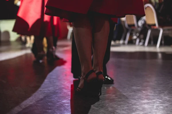 Dancing shoes of young couple, Couples dancing traditional latin argentinian dance milonga in the ballroom, tango salsa bachata kizomba lesson, dance festival, wooden floor, close view of shoes