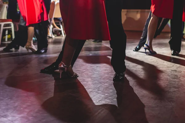 Dancing shoes of young couple, Couples dancing traditional latin argentinian dance milonga in the ballroom, tango salsa bachata kizomba lesson, dance festival, wooden floor, close view of shoes