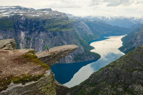 Яркая картина знаменитых норвежских мест для пеших прогулок - троллей, троллей, скал, скал, с туристом, а также озеро Рингедалсватнет и горный панорамный пейзаж, Норвегия — стоковое фото