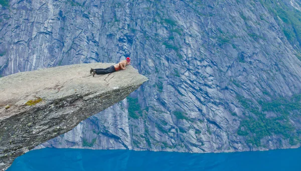 A vibrant picture of famous norwegian hiking place - trolltunga, the trolls tongue, rock skjegedall, with a tourist, and lake ringedalsvatnet and mountain panoramic scenery epic view, Norway — Stock Photo, Image