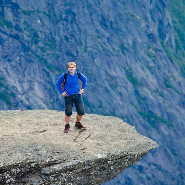 A vibrant picture of famous norwegian hiking place - trolltunga, the trolls tongue, rock skjegedall, with a tourist, and lake ringedalsvatnet and mountain panoramic scenery epic view, Norway — Stock Photo, Image