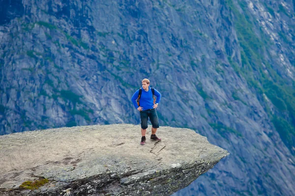 A vibrant picture of famous norwegian hiking place - trolltunga, the trolls tongue, rock skjegedall, with a tourist, and lake ringedalsvatnet and mountain panoramic scenery epic view, Norway — Stock Photo, Image