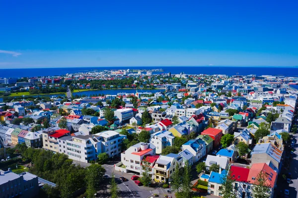 Beautiful super wide-angle aerial view of Reykjavik, Iceland with harbor and skyline mountains and scenery beyond the city, seen from the observation tower of Hallgrimskirkja Cathedral. — Stock Photo, Image