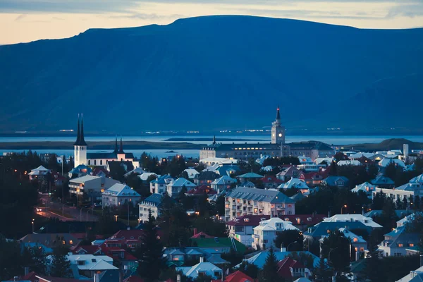 Beautiful super wide-angle aerial view of Reykjavik, Iceland with harbor and skyline mountains and scenery beyond the city, seen from the observation tower of Hallgrimskirkja Cathedral. — Stock Photo, Image